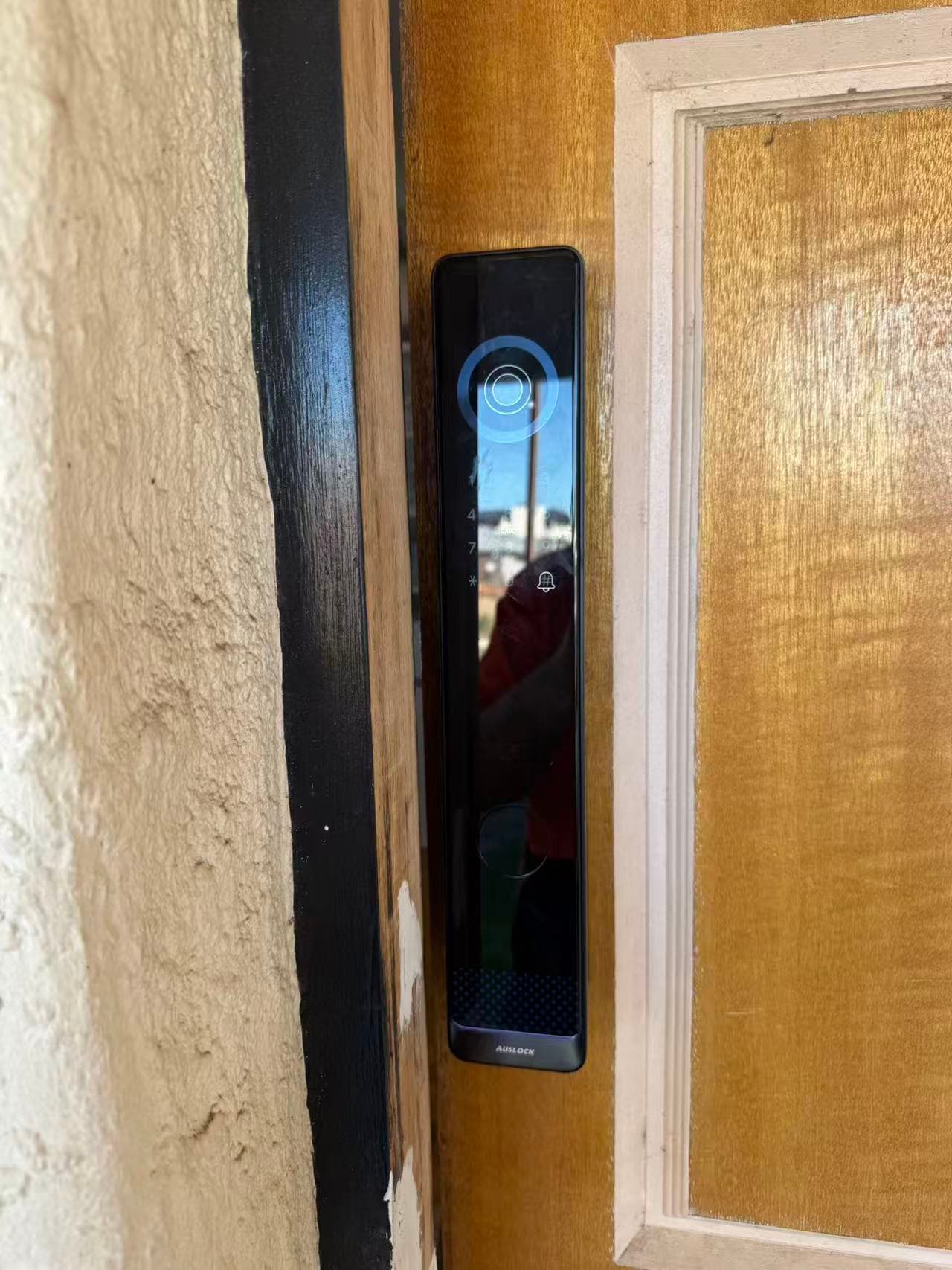 AUSLOCK smart lock front panel fitted to a timber door